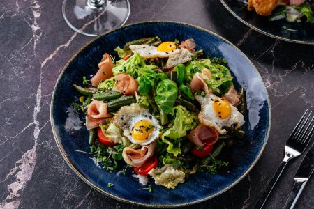Photo for Salad with quail eggs, bacon, vegetables, herbs and sauce - Royalty Free Image