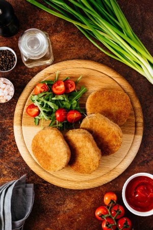 Photo for Chicken cutlets on a wooden board. vegetables and herbs - Royalty Free Image