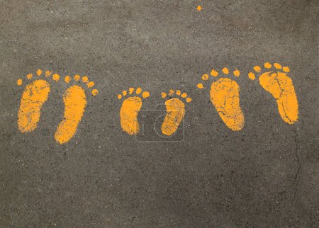 Téléchargez les photos : Empreintes peintes de la famille sur l'asphalte - en image libre de droit