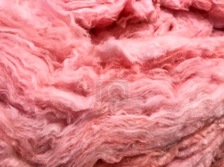 Photo for Pink layers of mineral fiberglass used for temperature insulation - Royalty Free Image