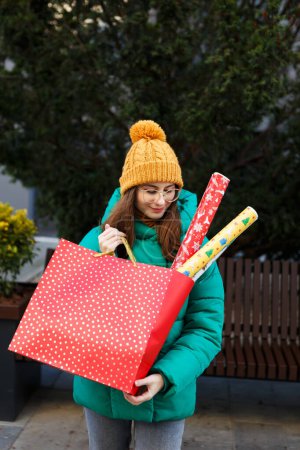 Photo for Woman holds Christmas packages of gifts in hands on holidays - Royalty Free Image