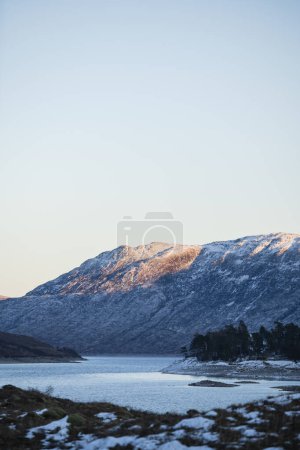 Téléchargez les photos : Vue des montagnes écossaises au crépuscule à travers le Loch Cluanie - en image libre de droit