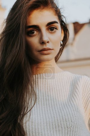 Photo for Brown-haired girl with big eyes in  white sweater - Royalty Free Image
