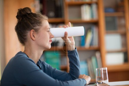 Photo for Young woman looking with paper telescope - Royalty Free Image