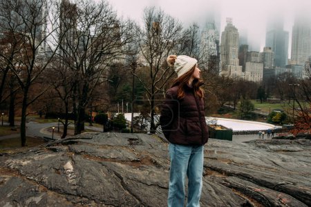 Photo for Teen girl looking over shoulder at New York skyline - Royalty Free Image