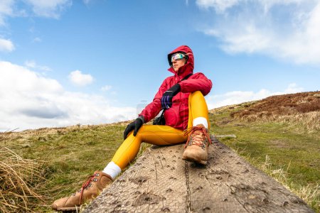 Foto de Mujer montañista sentada en pasarela de madera - Imagen libre de derechos