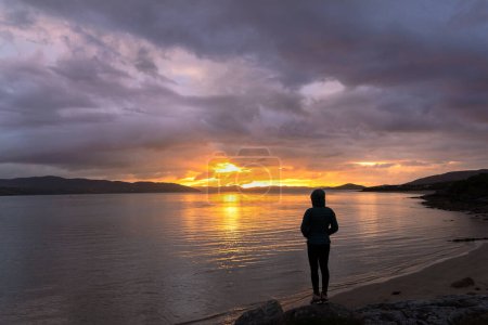 Photo for Woman watching beautiful sunset over Innis Owen peninsula - Royalty Free Image