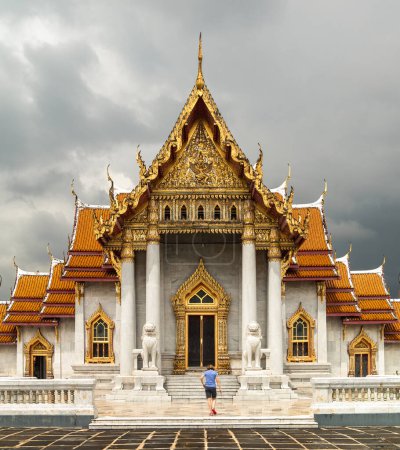 Photo for Woman entering the Thai Marble temple in Bangkok, Thailand - Royalty Free Image