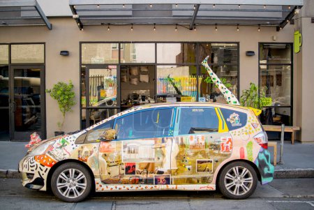 Photo for A fully decorated art car sits in front of George + Lennie Coffee Shop - Royalty Free Image