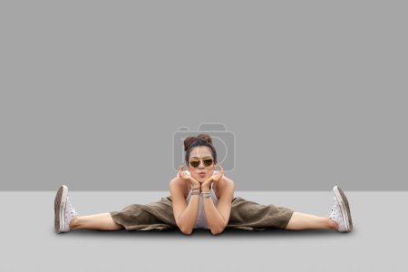 Photo for Young woman sitting in Wide-Angle Seated Forward Bend pose, - Royalty Free Image