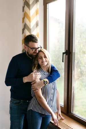 Photo for Young couple in home clothes hug during a lunch break - Royalty Free Image