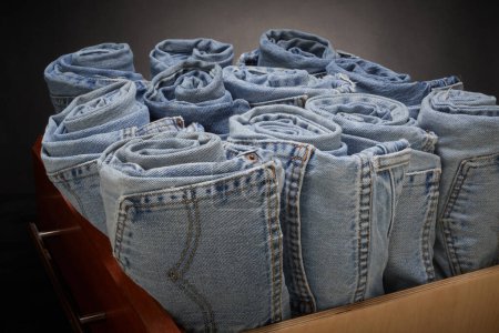 Photo for Faded blue jeans, rolled up and organized - Royalty Free Image