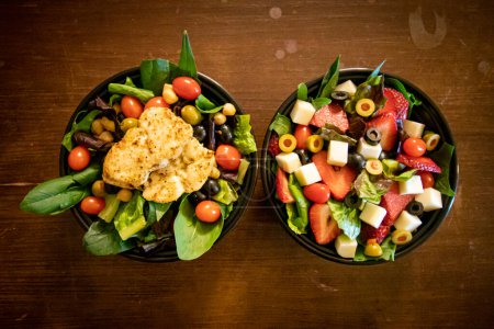 Photo for Two bowls of healthy salads with cheese and chicken - Royalty Free Image