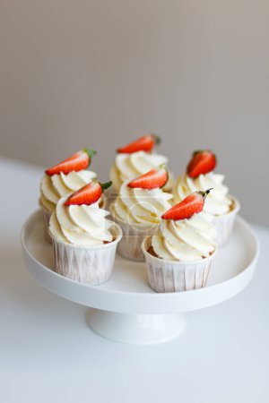 Photo for Cream cupcakes with fresh strawberries freshly prepared by pastry chef - Royalty Free Image