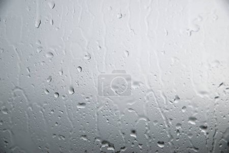 Photo for Water drops slipping on the glass of a vehicle. - Royalty Free Image