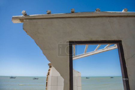 Photo for Abandoned house framing clear water beach in northeast Brazil - Royalty Free Image