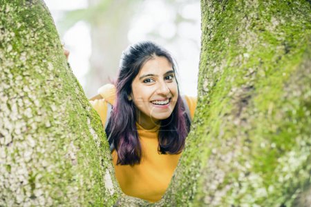 Photo for Young woman between trees - Royalty Free Image