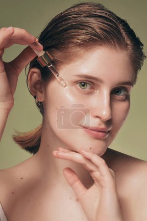 Photo for Close up model with fresh glowing skin and natural makeup on green - Royalty Free Image