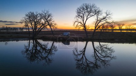 Photo for Sunrise Serenity: Van beside Calm Waters - Royalty Free Image