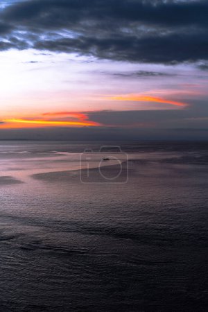 Photo for Sunset on the ocean, sun setting into the water. - Royalty Free Image
