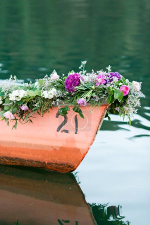 Foto de Guirnalda floral en un barco, reflejando serenidad y tradición - Imagen libre de derechos