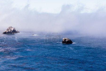 Photo for Mist-enshrouded sea rocks in the Pacific off the Big Sur coast - Royalty Free Image