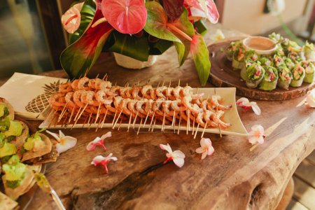 Photo for Tropical Shrimp appetizer display with spring roll and orchids - Royalty Free Image