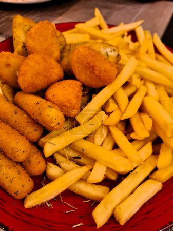evocative image of a plate of 'panelle, crocch and chips'typical street food in Palermo in Italy