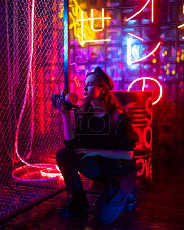 Photo for Caucasian woman with a gas mask in her hands in a neon studio - Royalty Free Image