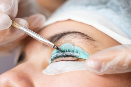 Close-up portrait of a woman on eyelash lamination procedure