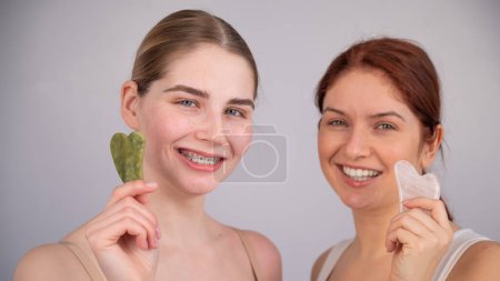 Photo for Portrait of two caucasian women with gouache scrapers on a white background - Royalty Free Image