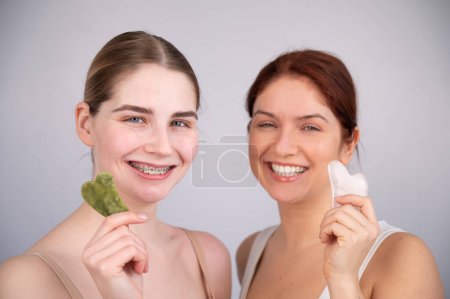 Photo for Portrait of two caucasian women with gouache scrapers on a white background - Royalty Free Image