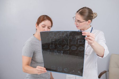 Photo for Female doctor explaining mri of internal organs to female patient - Royalty Free Image