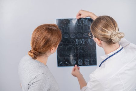 Photo for Female doctor explaining mri of internal organs to female patient - Royalty Free Image