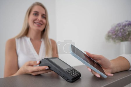 Photo for A woman pays using a non -contact payment of the NFC used by a smartphone - Royalty Free Image