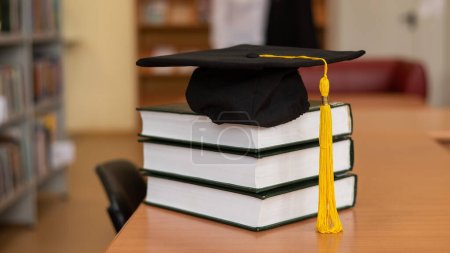 Photo for Graduation cap on a stack of books in the library - Royalty Free Image