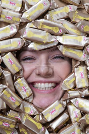 Photo for The face of a caucasian woman surrounded by Rakhat chocolates - Royalty Free Image
