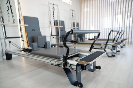 Photo for Two reformer machines. Pilates studio without people - Royalty Free Image