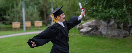 Photo for Caucasian woman in graduate gown dancing for joy outdoors - Royalty Free Image