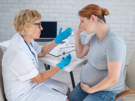 A pregnant woman cries during a doctors visit. Gestational diabetes