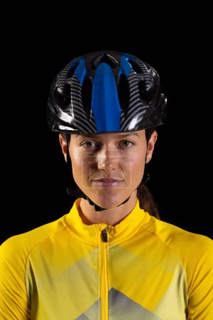 Young Caucasian woman wearing a cycling helmet, with copy space. She's dressed in athletic gear, suggesting a focus on sports and fitness.