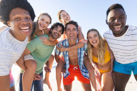 Diverse group of friends enjoy a day at the beach. Captured in a joyful moment, they embody the spirit of summer fun outdoors.