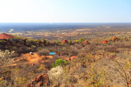 Téléchargez les photos : Red roofs of the Waterberg Plateau Lodge in Namibia nestling high on the slope of Waterberg with views across the endless Kalahari. Namibia. - en image libre de droit