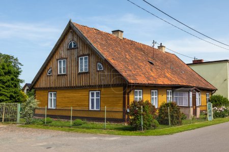 Photo for Tujsk, Zulawy, Poland - 15 June 2019: Traditional wooden buildings in village of Tujsk. Spring season. Zulawy, Poland. - Royalty Free Image