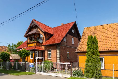 Photo for Tujsk, Zulawy, Poland - 15 June 2019: Traditional wooden buildings in village of Tujsk. Spring season. Zulawy, Poland. - Royalty Free Image
