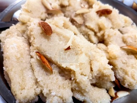 Photo for Plain Semolina/Suji Halwa also known as Sweet Rava Sheera or Shira - Indian festival sweet garnished with dry fruits. Served in a plate or Bowl, selective focus - Royalty Free Image