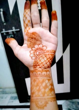 Photo for A Beautiful artwork drawn on the hand of an Indian bride with herbal heena in wet condition. - Royalty Free Image