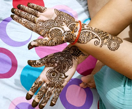 Photo for A Beautiful artwork drawn on the hand of an Indian bride with herbal heena in wet condition. - Royalty Free Image