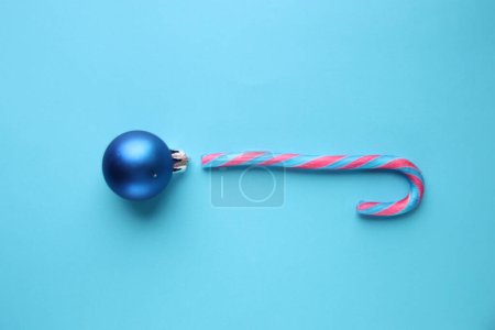 Photo for Merry Christmas creative card. Candy cane and Christmas Bauble . - Royalty Free Image