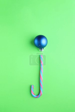 Photo for Merry Christmas creative card. Candy cane and Christmas Bauble . - Royalty Free Image